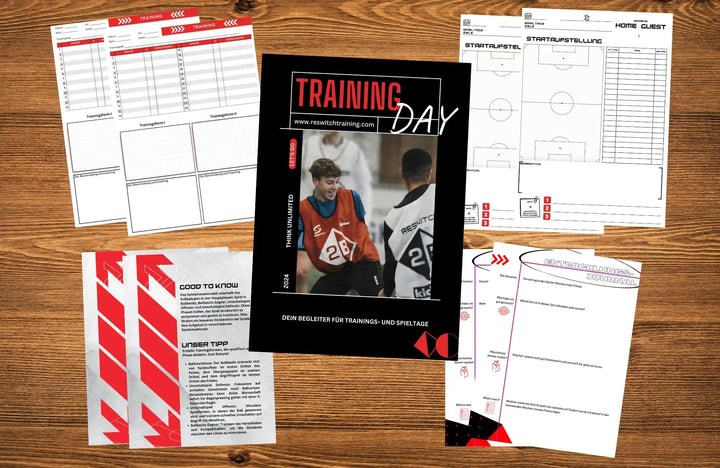 Das Trainings- und Spielbegleiter – Reswitch Trainingsbuch von matchconcept UG mit Mannschaftsaufstellungs- und Strategieblättern und zwei lächelnden Spielern in roten Leibchen auf dem Cover liegt ausgebreitet auf einem Holztisch.