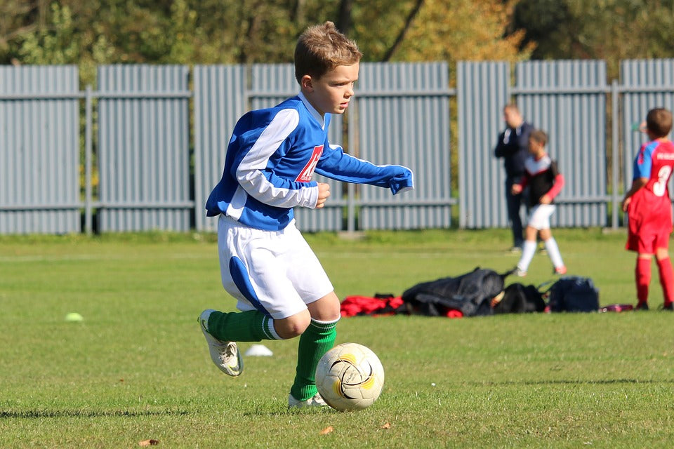 Zu sehen auf diesem Bild it ein junger Fussballspieler, der Fussballspielt